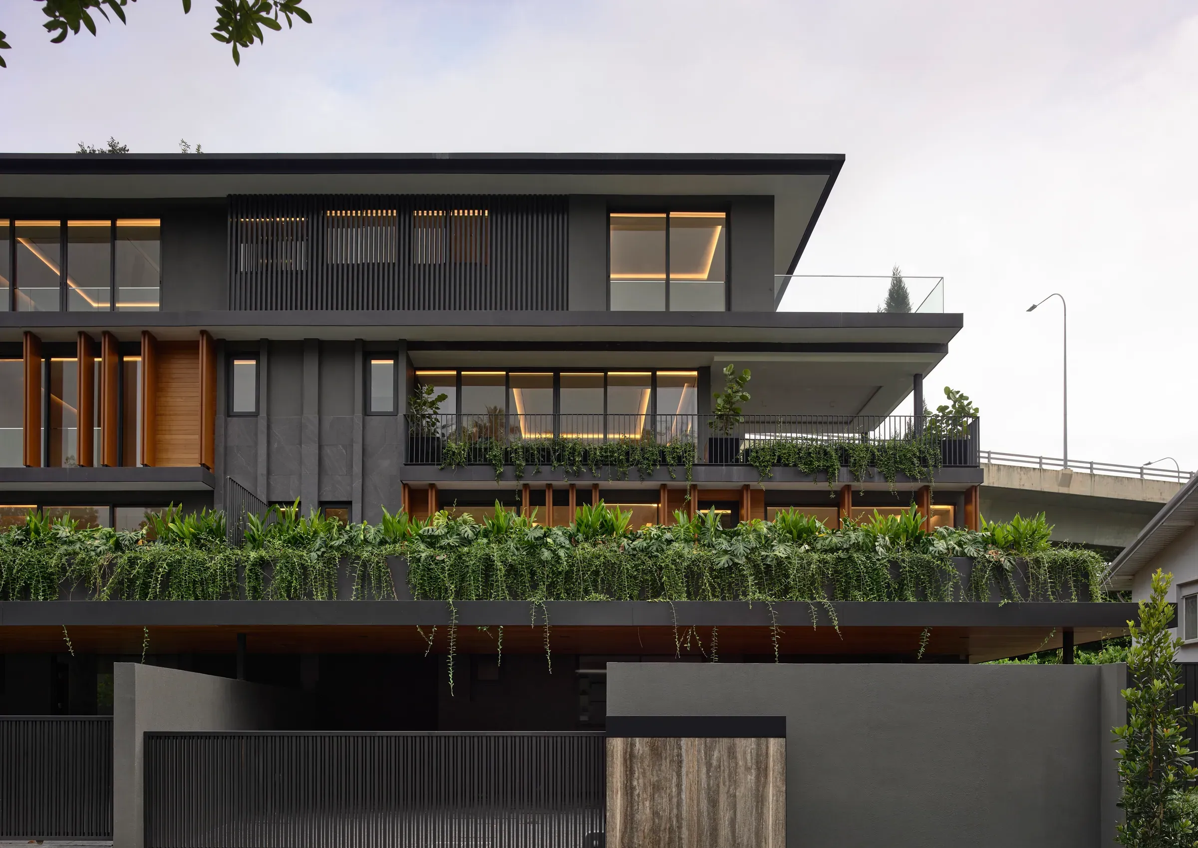 The Caspian House from the street, its planted ledge running the width of the elevation.